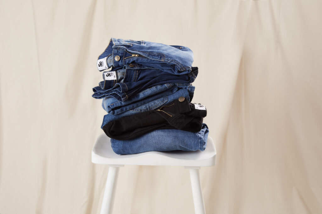 Denim jeans stacked on a chair